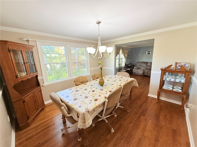 dining space with a chandelier, dark hardwood / wood-style floors, and ornamental molding