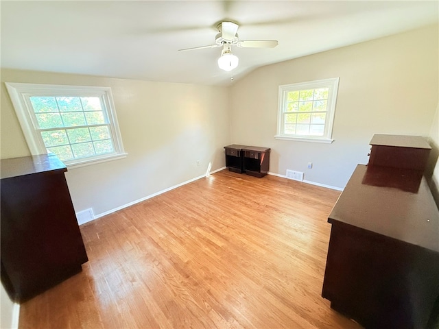 interior space featuring ceiling fan, light hardwood / wood-style floors, and lofted ceiling