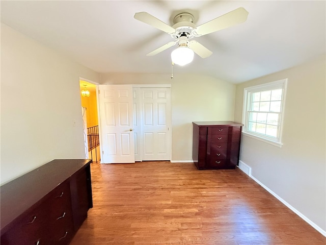 unfurnished bedroom with ceiling fan, a closet, and light hardwood / wood-style flooring