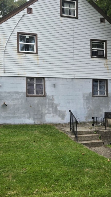 view of side of home featuring a lawn