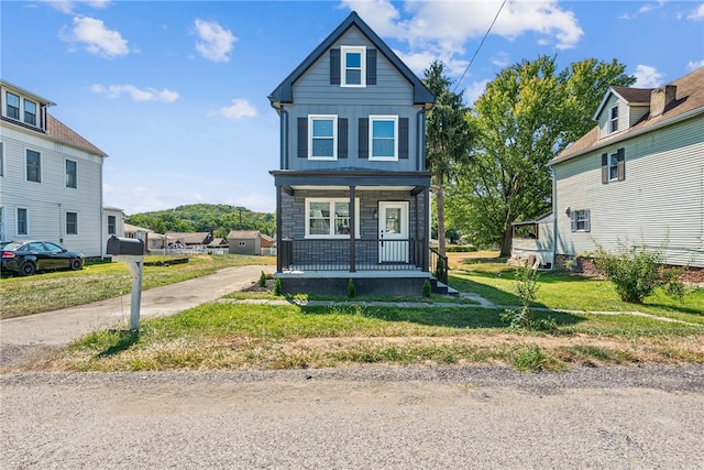 view of front property featuring a front yard and a porch