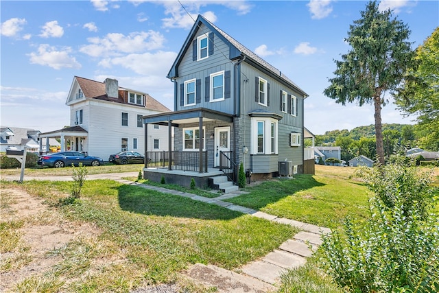 view of front of property featuring cooling unit and a front lawn