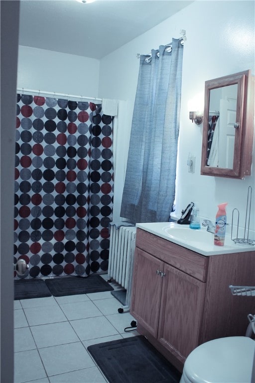 bathroom featuring tile patterned floors, toilet, radiator, and vanity