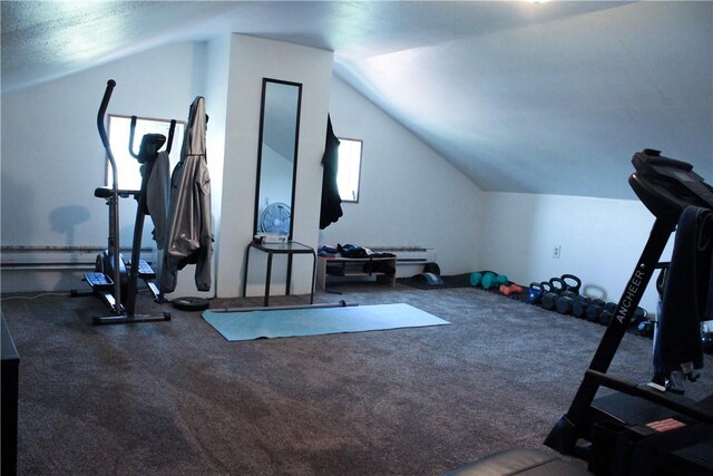 workout area featuring vaulted ceiling and carpet