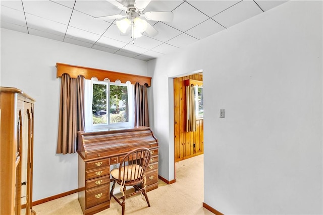 office area with baseboards, a ceiling fan, and light colored carpet