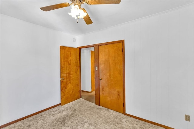 unfurnished room featuring carpet flooring, ceiling fan, and baseboards