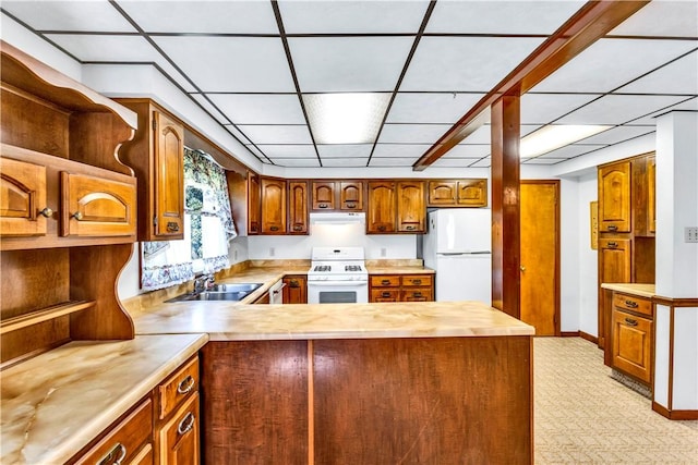 kitchen with white appliances, a peninsula, light countertops, open shelves, and a sink