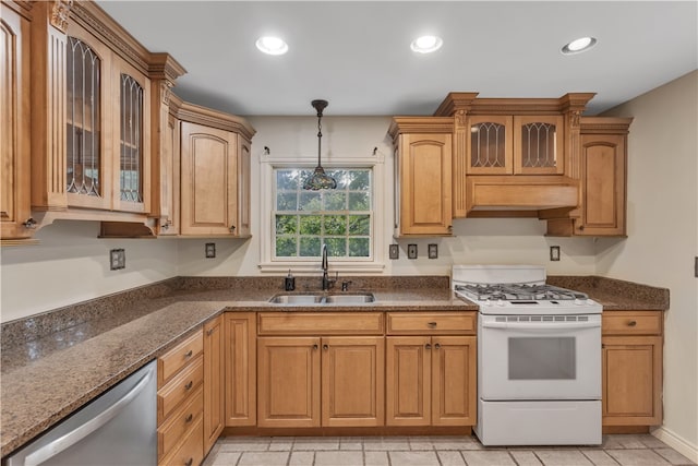 kitchen featuring gas range gas stove, hanging light fixtures, sink, light tile patterned flooring, and stainless steel dishwasher