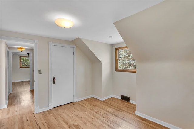 bonus room with light wood-type flooring