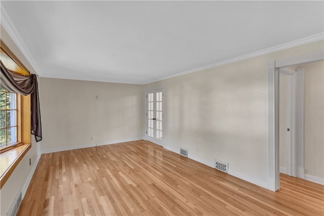 unfurnished room featuring ornamental molding, french doors, and light hardwood / wood-style flooring