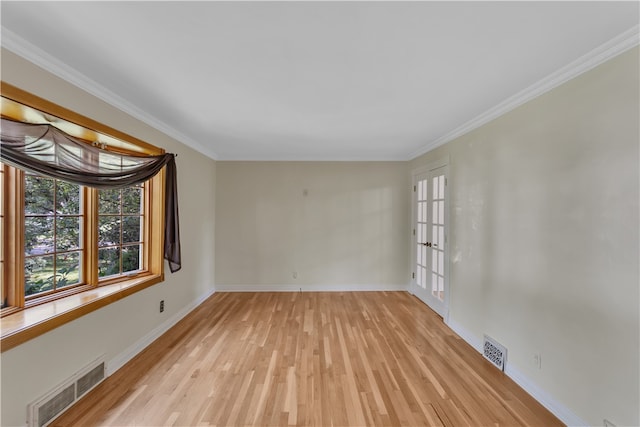 unfurnished room with light hardwood / wood-style floors and crown molding