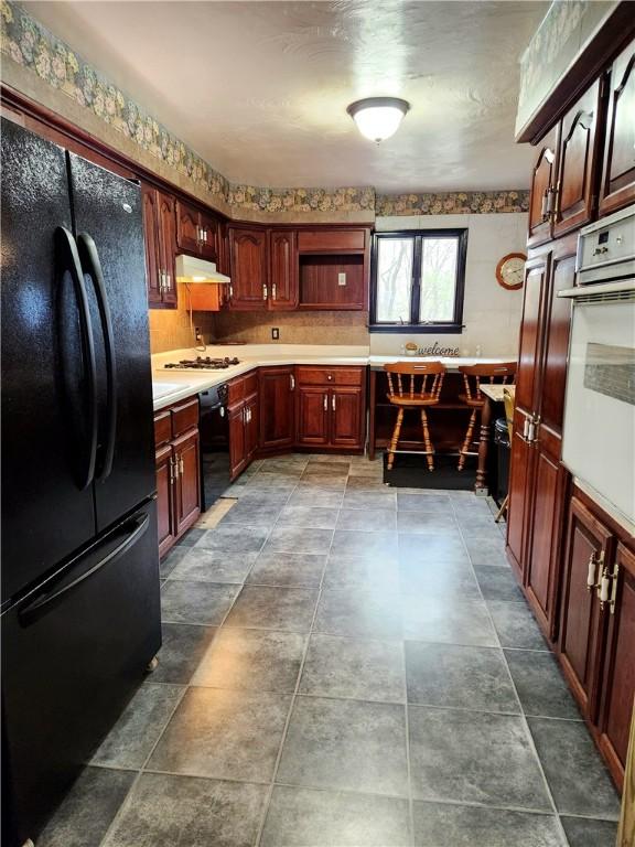 213 Fern St, Hopewell Twp Bea, PA 15001 - kitchen featuring black appliances, open shelves, under cabinet range hood, and light countertops