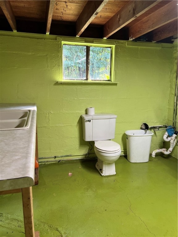 bathroom with toilet, sink, and wooden ceiling