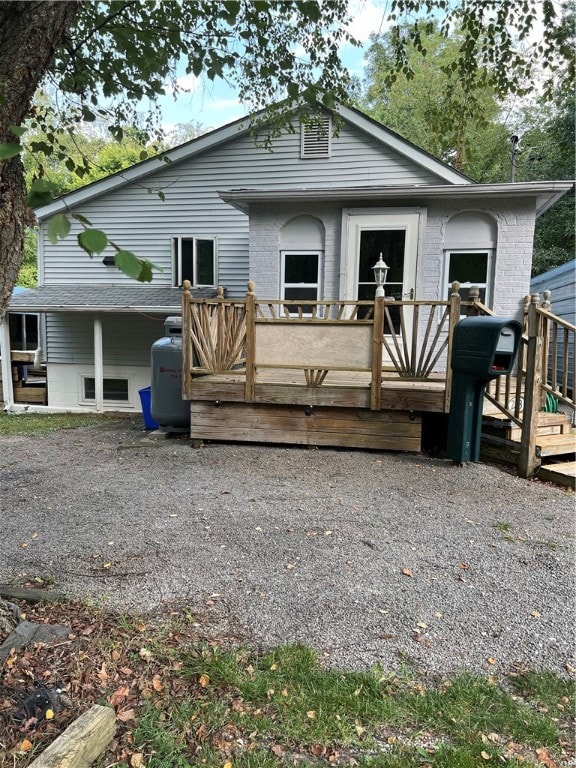 back of property with a wooden deck