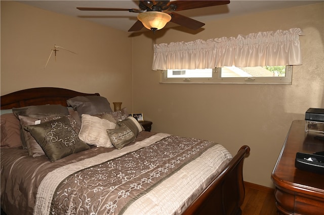 bedroom featuring dark wood-type flooring and ceiling fan