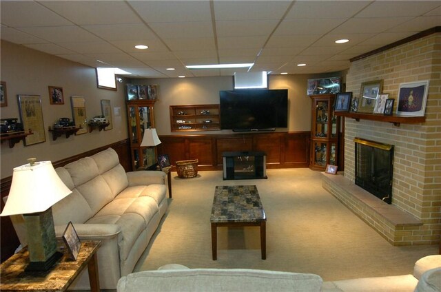 905 Morton Ave, Port Vue, PA 15133 - carpeted living room with a brick fireplace, a drop ceiling, recessed lighting, and wainscoting