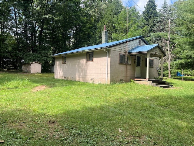 view of home's exterior featuring a yard and a shed