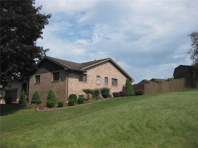 view of side of home featuring a yard