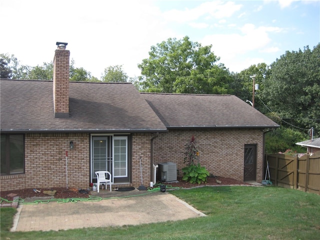 back of house with a patio area, a yard, and central air condition unit