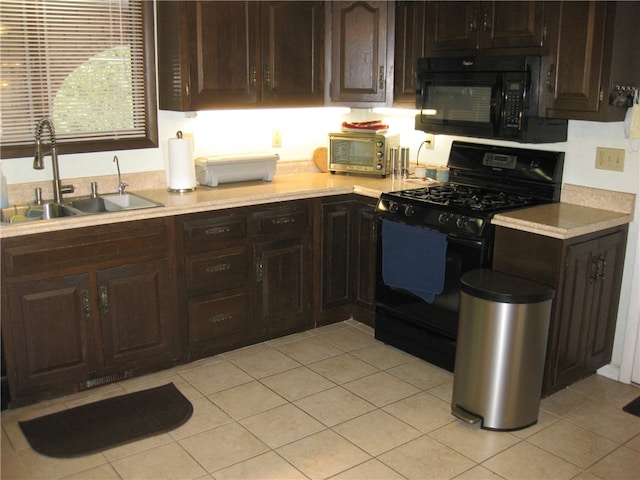 kitchen featuring black appliances, sink, light tile patterned floors, and dark brown cabinets