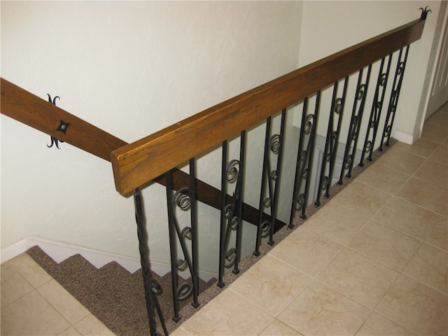 stairway featuring tile patterned floors