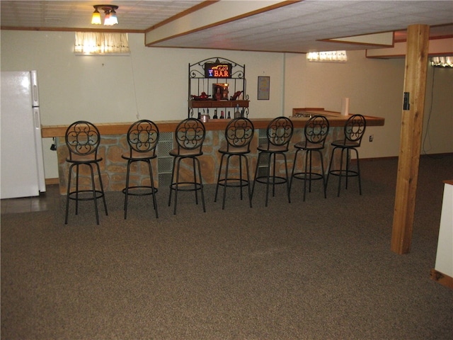 carpeted dining area with indoor bar