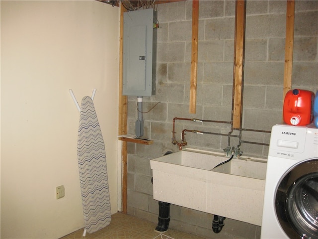 laundry room featuring tile patterned flooring, electric panel, sink, and washer / clothes dryer