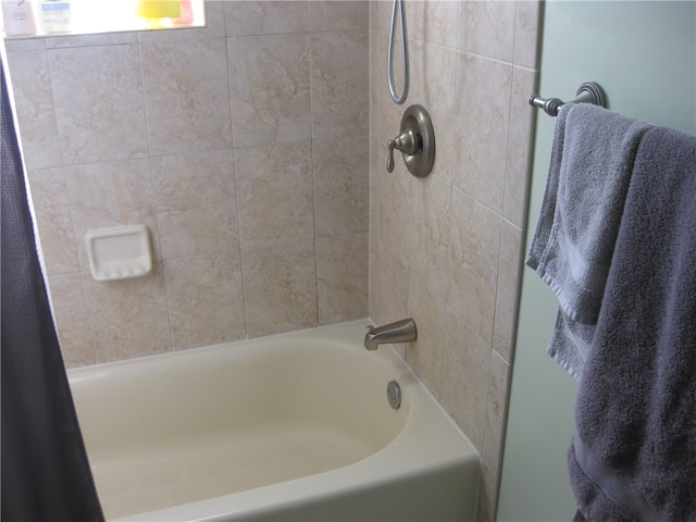 bathroom with shower / tub combo with curtain