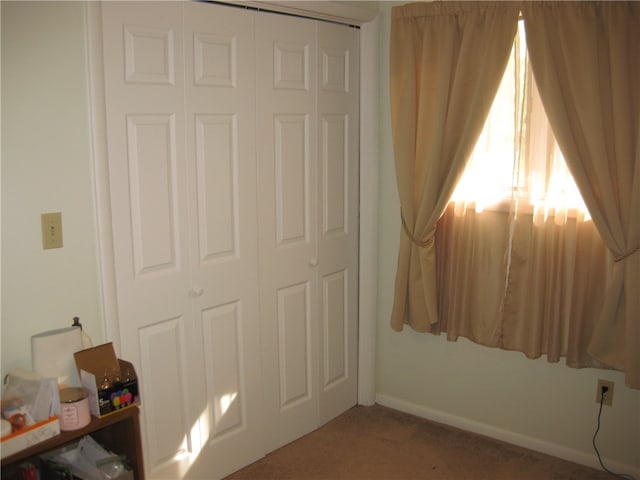 carpeted bedroom featuring a closet