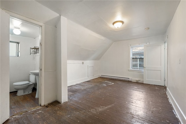 additional living space featuring lofted ceiling, baseboard heating, and hardwood / wood-style flooring