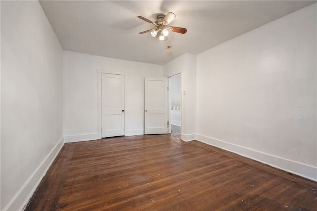 unfurnished bedroom featuring hardwood / wood-style flooring, baseboards, and a ceiling fan