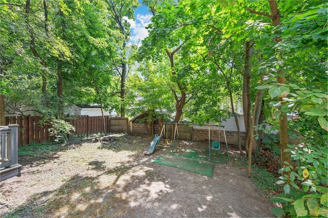 view of yard with a playground and a fenced backyard