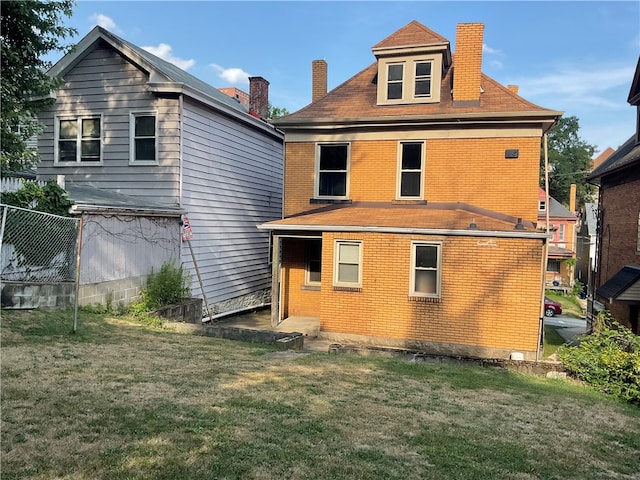 rear view of house with a lawn