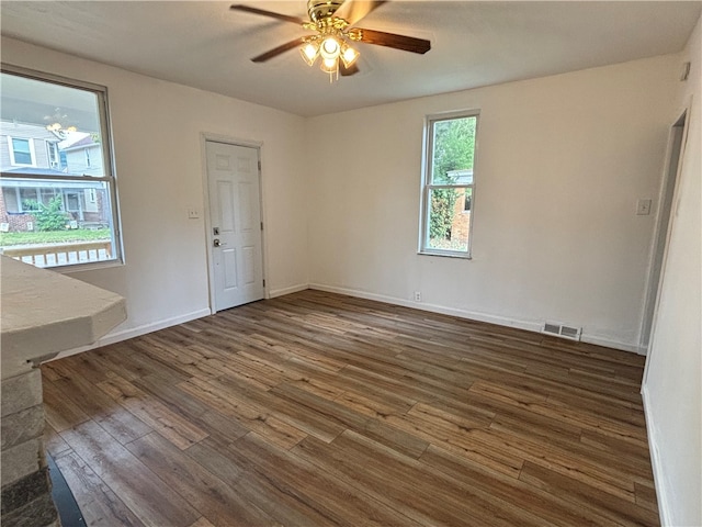 unfurnished bedroom featuring dark wood-type flooring and ceiling fan