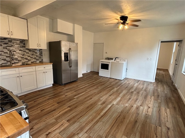 kitchen featuring separate washer and dryer, white cabinetry, stainless steel appliances, and ceiling fan