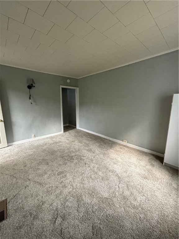 spare room with carpet flooring and ornamental molding