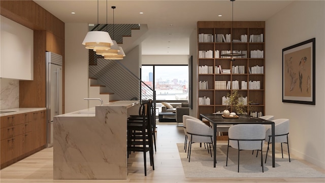 dining area with light hardwood / wood-style flooring and sink