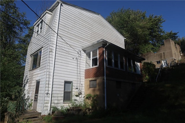 view of side of property featuring brick siding