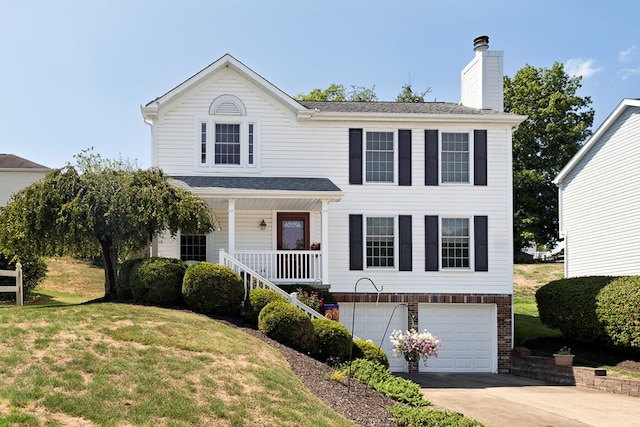 view of front of property featuring covered porch, a front yard, and a garage