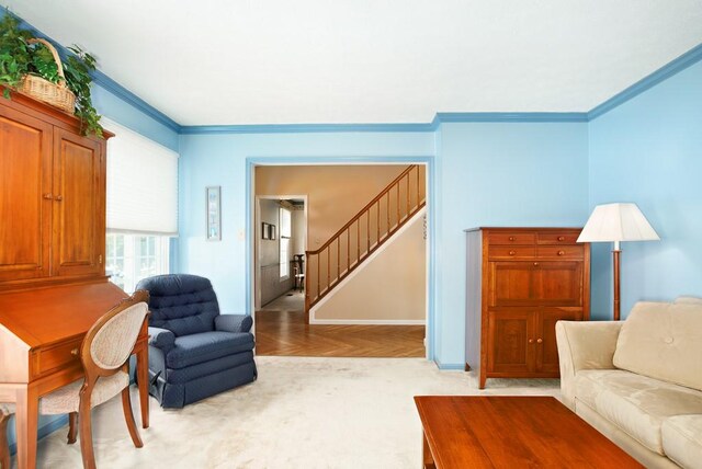 living room featuring light parquet floors and ornamental molding