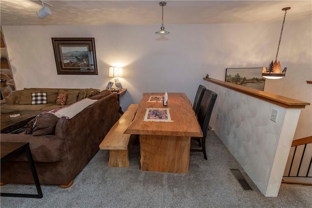 carpeted dining space with visible vents