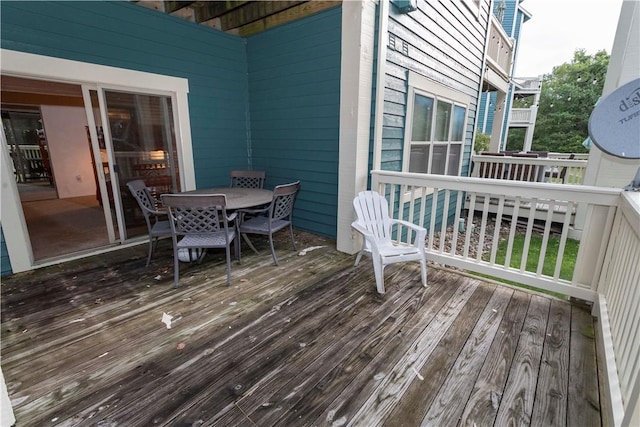 wooden terrace featuring outdoor dining area
