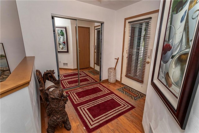 foyer with visible vents and wood finished floors