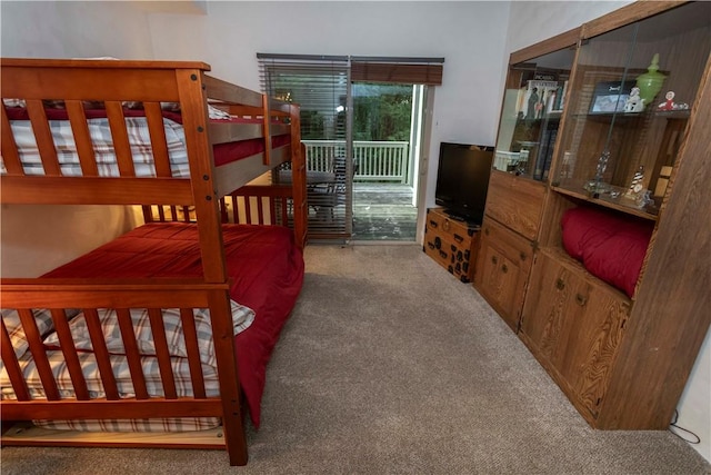 bedroom with carpet and access to outside