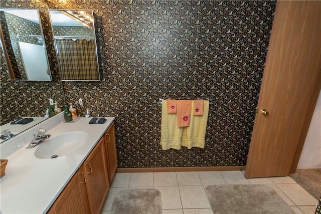 bathroom featuring baseboards, tile patterned flooring, and vanity