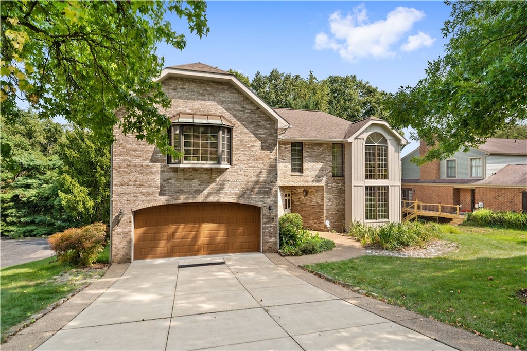 view of front of home with a garage and a front lawn