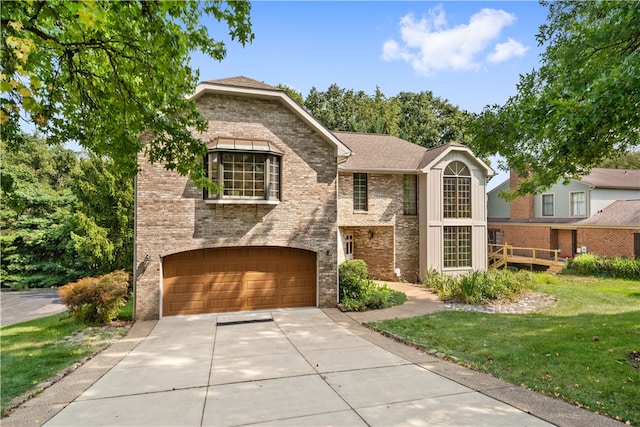 view of front of home with a garage and a front lawn