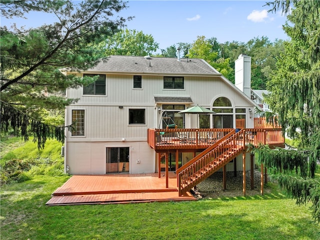 back of house with a yard and a deck