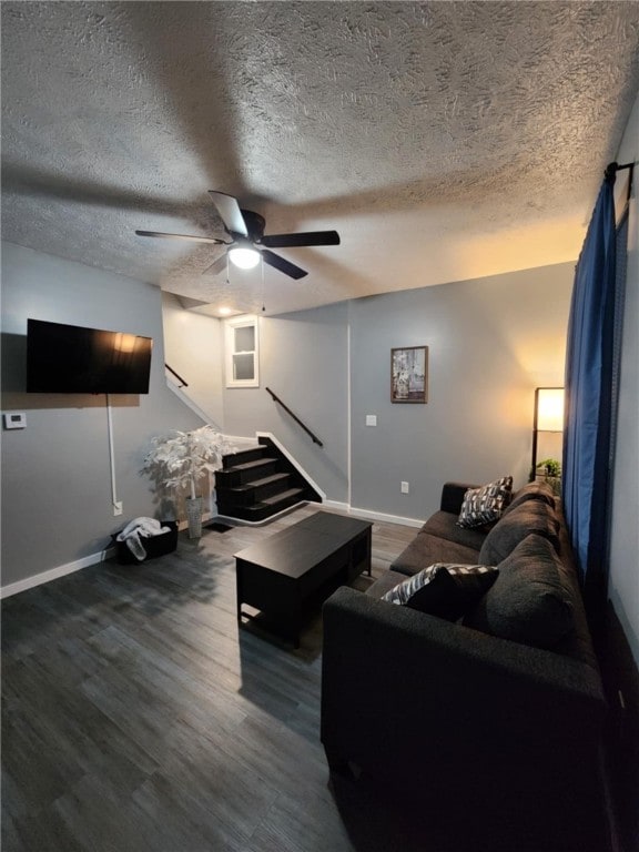 living room with ceiling fan, hardwood / wood-style flooring, and a textured ceiling