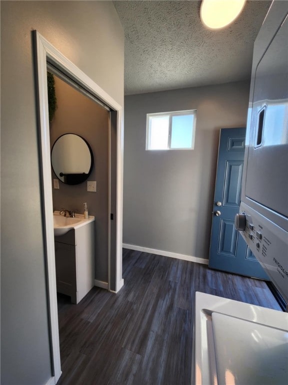 interior space featuring a textured ceiling, sink, and dark hardwood / wood-style floors